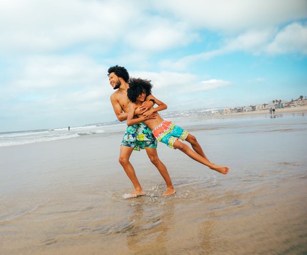 Father and son playing at a beach in San Diego during the summer