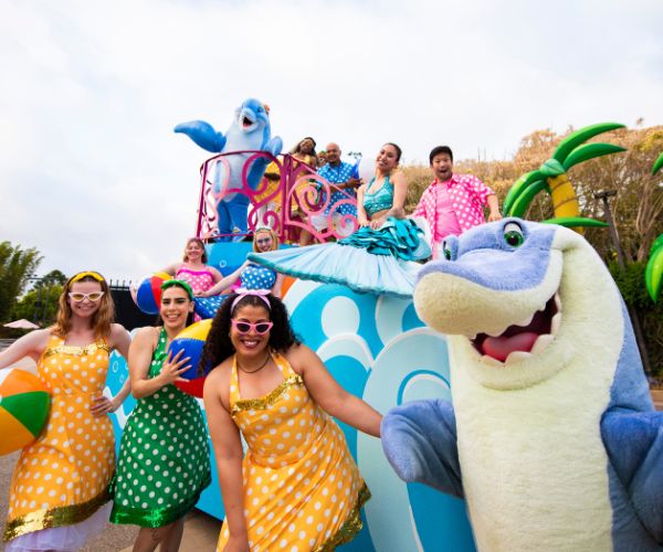 A parade float from Summer Spectacular with sea characters and smiling humans