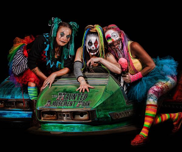 Scary clowns atop a broken down bumper car at The Haunted Amusement Park