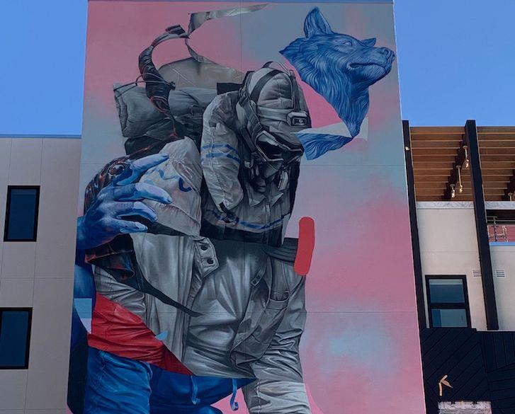 Towering figures of man and animal dominate Joram Roukes' mural on the Found Lofts building in Vista.