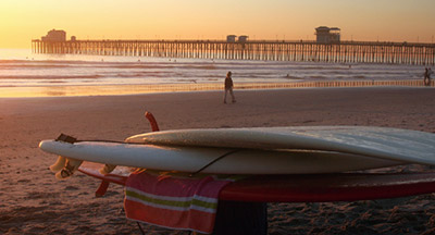 Oceanside CA pier surfboards stacked at sunset