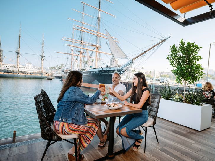 Family dining outdoors at the Portside Pier