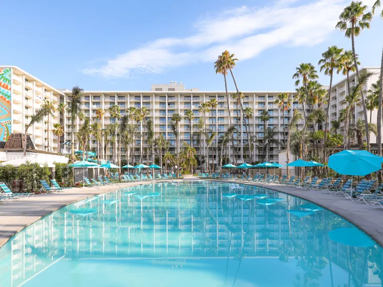 The outside of the Town and Country Resort pool side looking over a clear blue pool