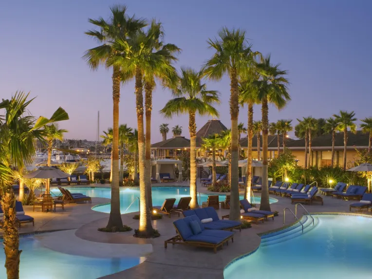 The Pool of the Hyatt Regency Mission Bay taken on a clear night just after sunset with the lights shining on palm trees in Mission Bay, San Diego 
