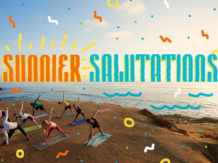 A group of people practice yoga on mats by the ocean at sunrise, with the words "Summer Salutations" illustrated above them.