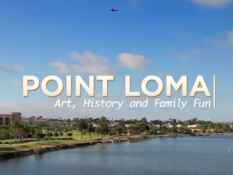 A scenic waterfront view of Point Loma with palm trees, buildings, and a plane flying overhead. Text on image reads: "Point Loma: Art, History and Family Fun.