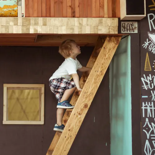 Young boy climbing up stairs inside of museum