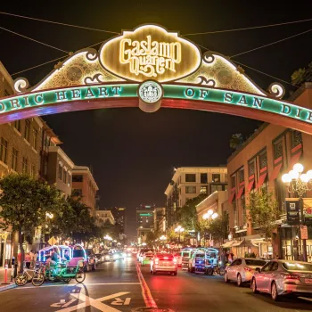 A nighttime view of the arched Gaslamp Quarter sign in Downtown San Diego.