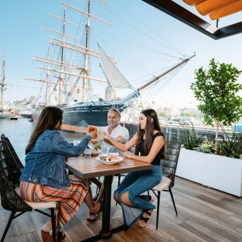 Family clinking glass with a great meal at Portside Pier on San Diego Bay 