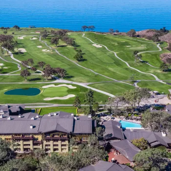 Aerial shot of the Lodge at Torrey Pines Resort with the Torrey Pines Golf Course stretching out toward the Pacific Ocean