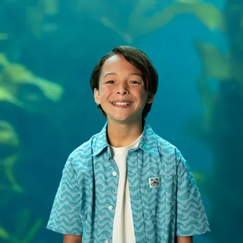 Young boy in front of an tank of marine life at Birch Aquarium in San Diego, CA