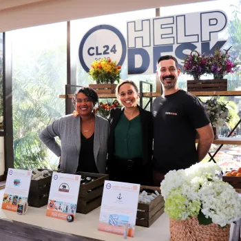 Three people standing at a convention help desk at the San Diego Convention Center