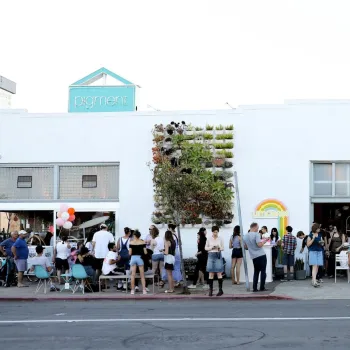 A group of people congregates on a sunny day outside of the Pigment store in San Diego's North Park neighborhood.