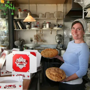 A baker holds pies amid stacked boxes inside Mom's Pie Shop in beautiful Julian, in the mountains near San Diego.