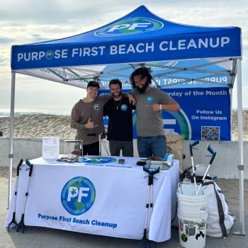 Three men standing under a Purpose First 10x10 on Pacific Beach in San Diego CA.