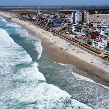 Aerial of a beach in Tijuana Mexico near the border with San Diego in the background