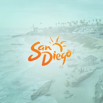 A beach scene with people walking and relaxing near the ocean, overlaid with the orange "San Diego" logo and a sun graphic.