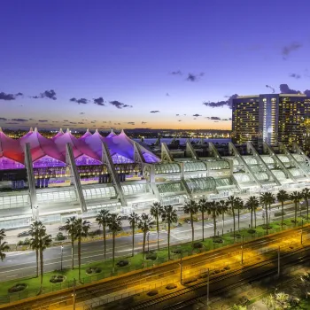 San Diego Convention Center on a clear night at dusk with the lights on in downtown San Diego