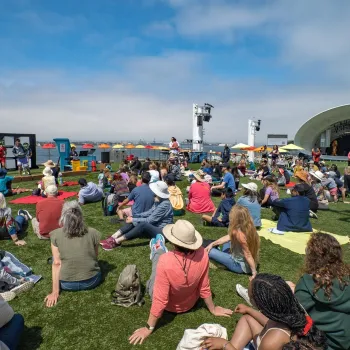 Free Event in San Diego at the Rady Shell a large group of people sitting on the lawn of the Rady Shell