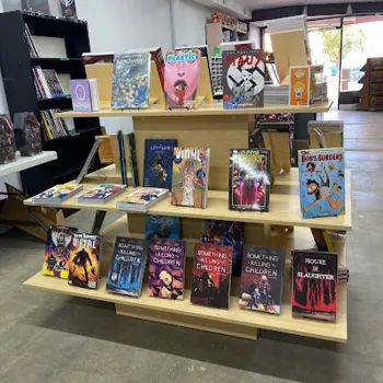 Display shelf in a comic book store featuring various graphic novels and comic books, including "Bob's Burgers" and "Something is Killing the Children.