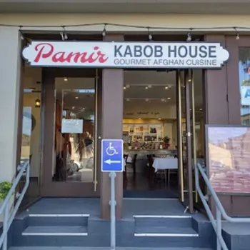 Entrance of Pamir Kabob House, a restaurant offering gourmet Afghan cuisine, with a visible “OPEN” sign and a wheelchair accessible ramp.