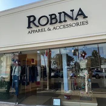 Street view of the storefront for "Robina Apparel & Accessories," featuring glass doors, display mannequins, and clothing inside.