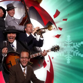 Seven men in suits play various instruments including saxophone, trumpet, guitar, and drums against a festive background with snowflakes and red decorations.