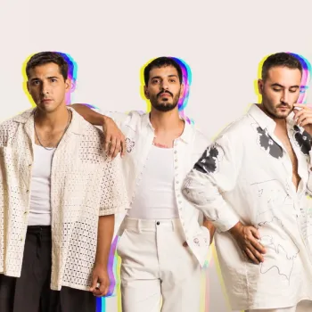 Three men stand side by side against a plain background, all dressed in white and light-colored outfits, looking toward the camera with neutral expressions.