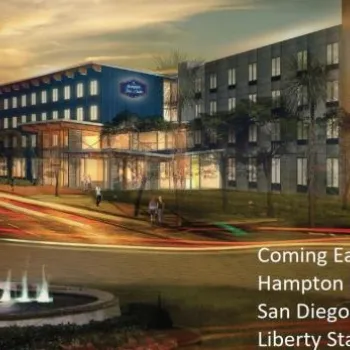 Rendering of Hampton Inn and Suites at San Diego Airport, Liberty Station, with a fountain in the foreground and announcement text about opening in early 2019.