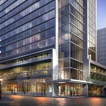 Modern high-rise building with glass facade and street-level retail, situated on a city corner with people walking nearby.