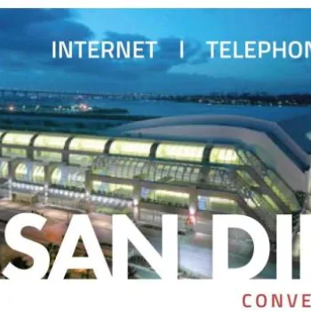 Aerial view of the San Diego Convention Center at dusk, with Smart City logo and text advertising internet, telephone, and cable TV services.