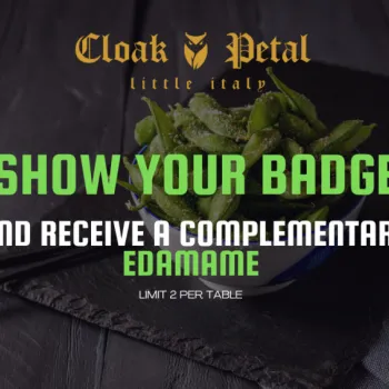 A bowl of edamame with chopsticks beside text offering complimentary edamame at Cloak & Petal for showing a badge, limited to 2 per table.