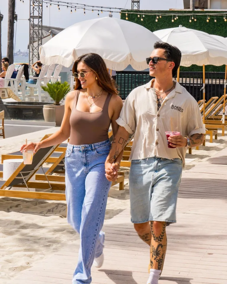 A couple strolls along a wooden walkway through FIT Social under sunny skies in the Pacific Beach community of San Diego.
