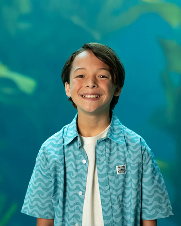 Young boy in front of an tank of marine life at Birch Aquarium in San Diego, CA