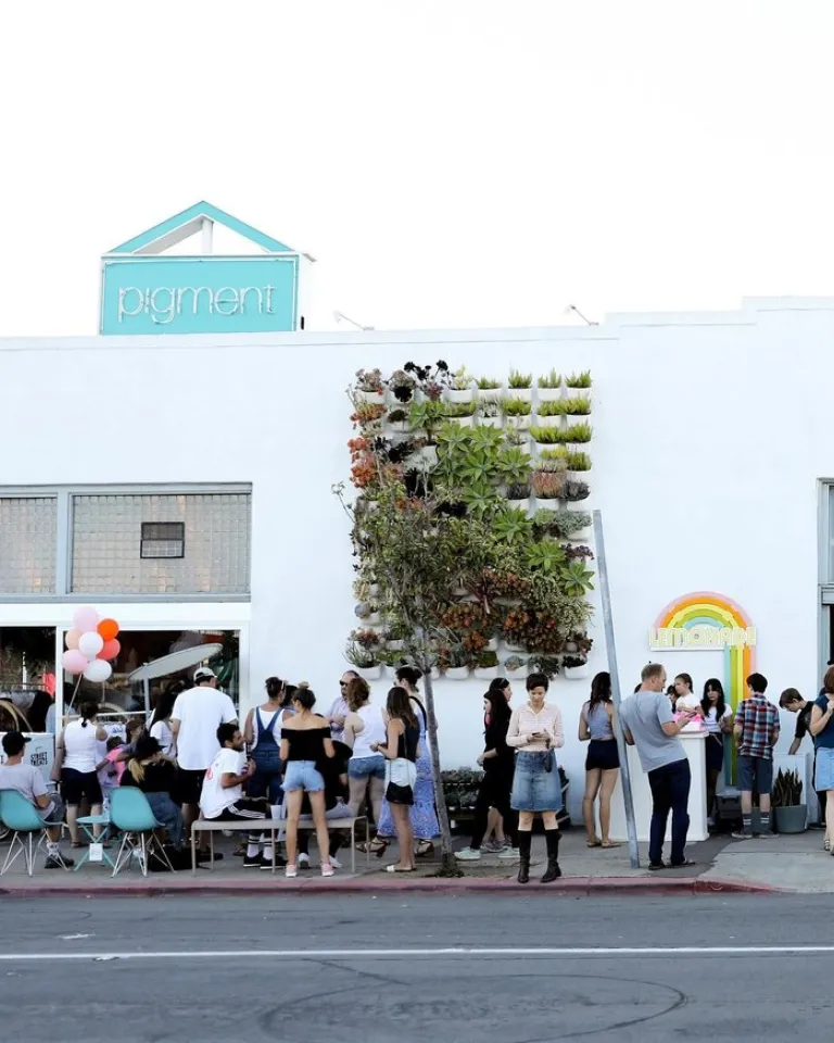 A group of people congregates on a sunny day outside of the Pigment store in San Diego's North Park neighborhood.