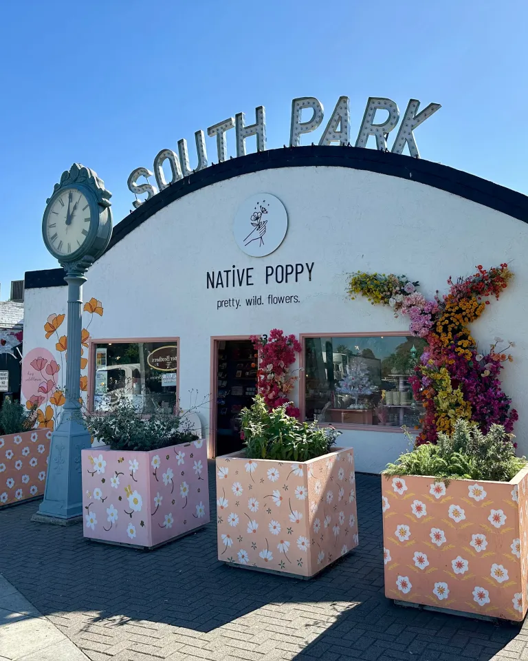 South Park neighborhood sign over Native Poppy store with a clock in this San Diego neighborhood 