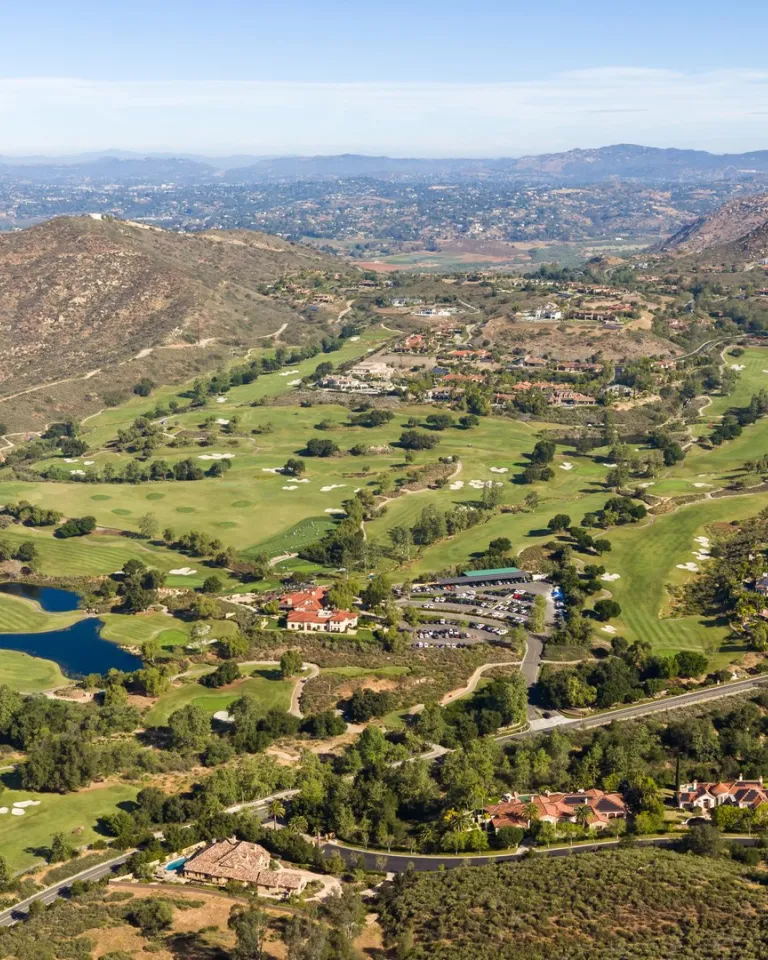 An aerial view of San Diego's Rancho Bernardo neighborhood, showing green expanses, roadways and houses.