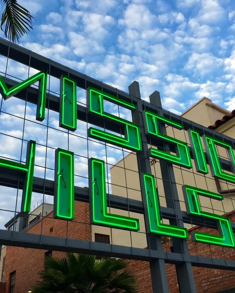 A sign in green letters reads "Mission Hills" in the Uptown neighborhood of San Diego.