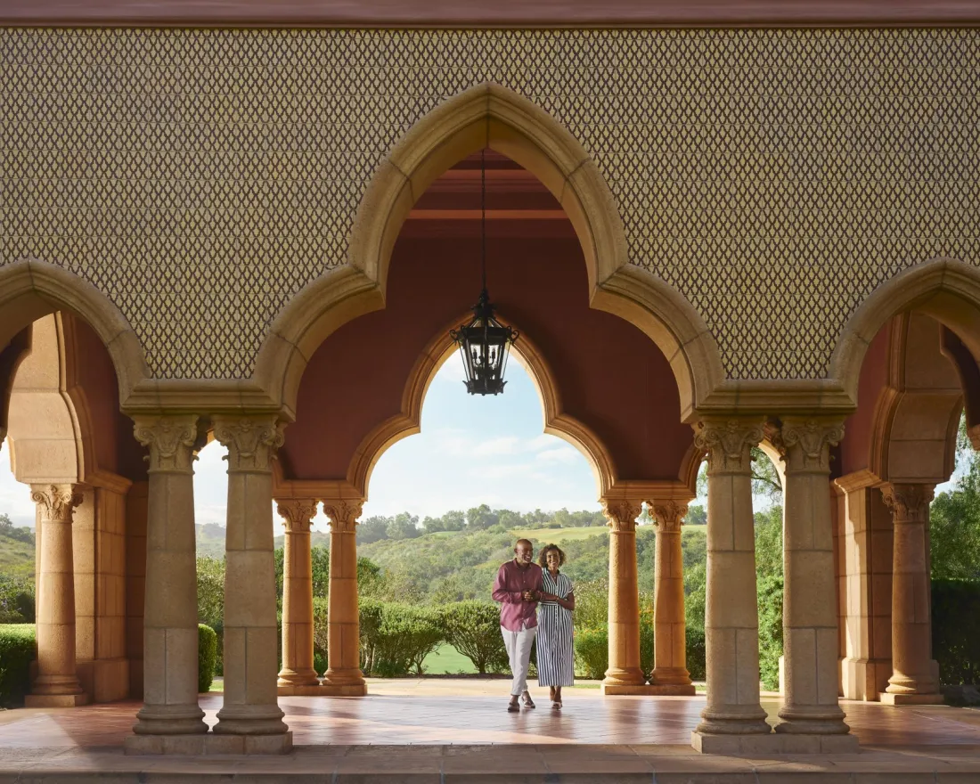 Couple walking along the promenade at the Fairmont Grand Del Mar in San Diego
