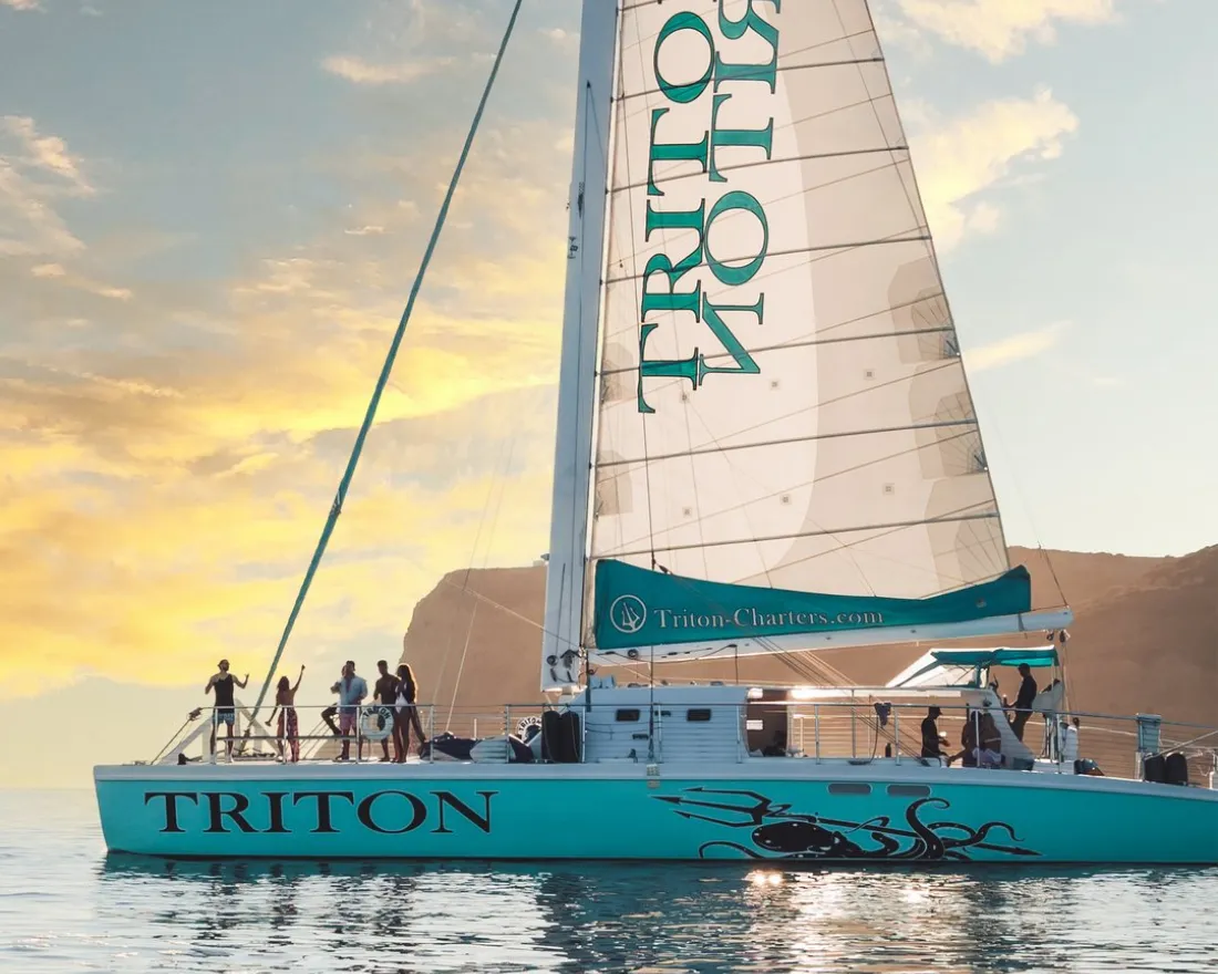 Group of people on a luxury charter sail boat in San Diego bay at sunset