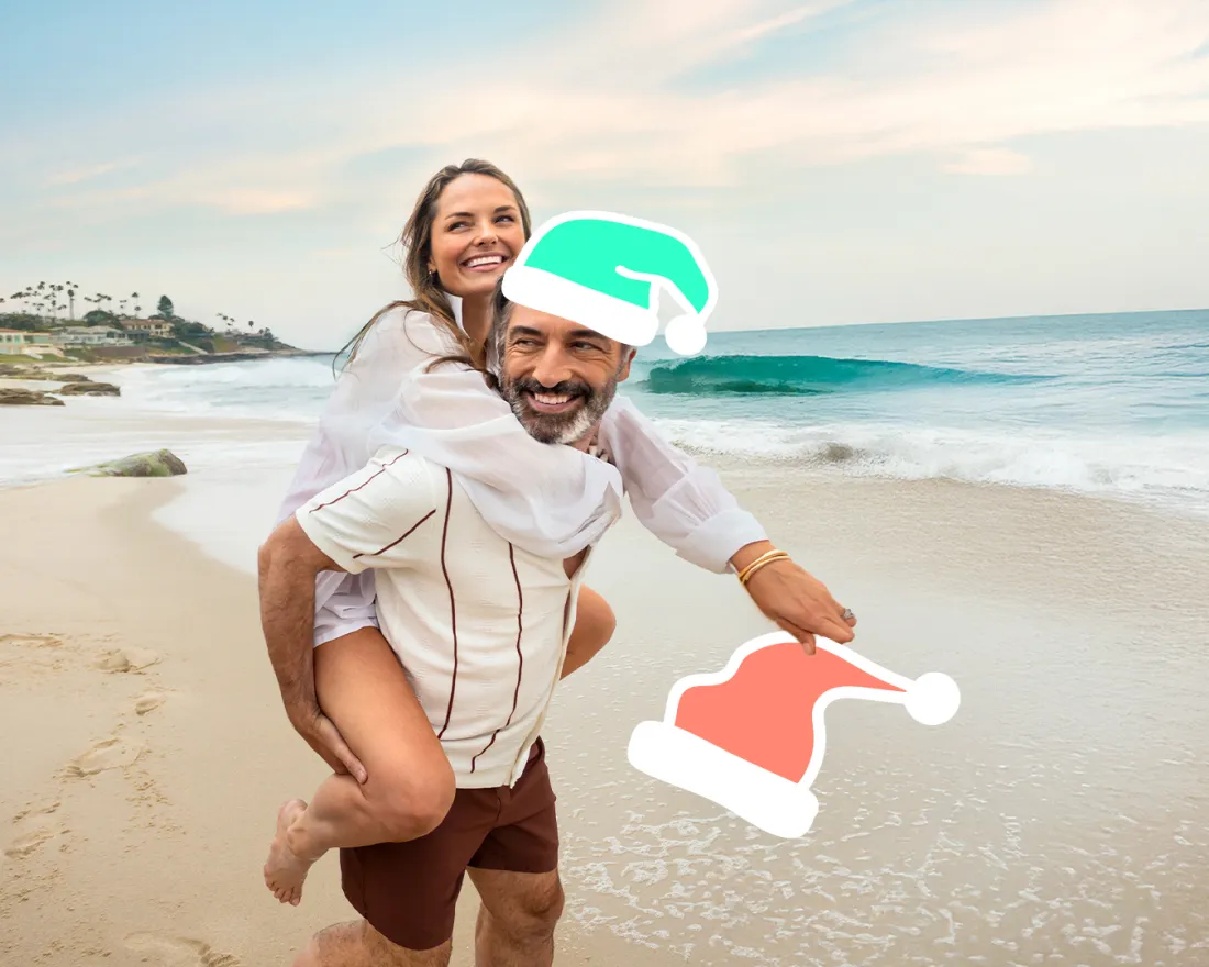 Couple on the beach in San Diego with Santa hat graphics added to their head