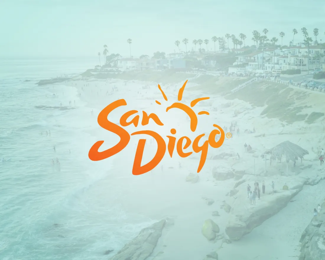 A coastal beach scene in San Diego with people on the sand and in the water, overlaid with an orange "San Diego" logo featuring a stylized sun.