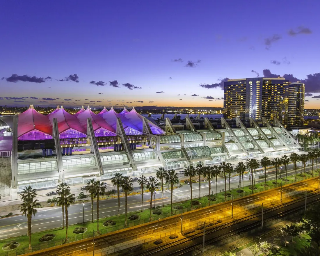 San Diego Convention Center on a clear night at dusk with the lights on in downtown San Diego