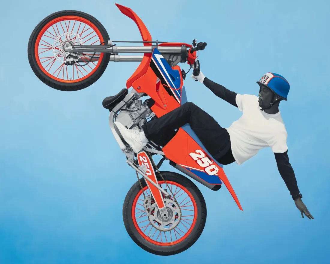 A person performs a wheelie on a red and blue motorcycle against a blue background, in this image of a work by Amy Sherald that's part of the "Giants" art exhibit co-organized by Alicia Keys at the Museum of Contemporary Art San Diego in La Jolla.
