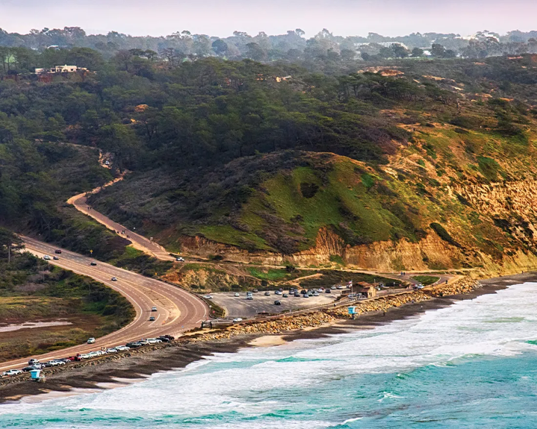 Aerial view of San Diego's coast with parking lot and cliffs of Torrey Pines State Beach