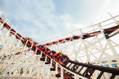 Riders on a roller coaster at Belmont Park in San Diego