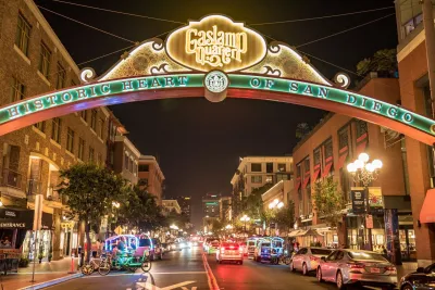 A nighttime view of the arched Gaslamp Quarter sign in Downtown San Diego.