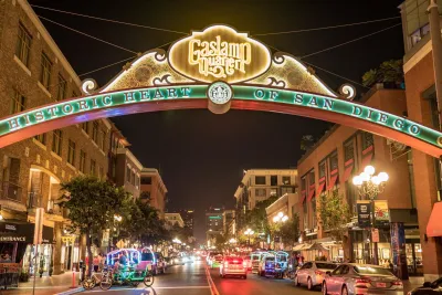 A nighttime view of the arched Gaslamp Quarter sign in Downtown San Diego.