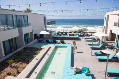 Couple enjoying the pool overlooking the Pacific Ocean at a hotel in San Diego