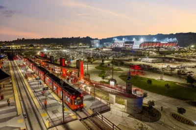 Trolley is stopped outside of Snapdragon Stadium at dusk in San Diego, CA